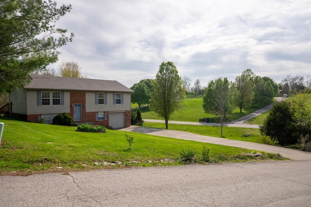 split foyer home with brick siding, an attached garage, a front yard, and concrete driveway