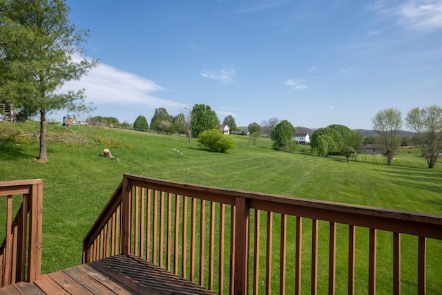 deck featuring a rural view and a yard