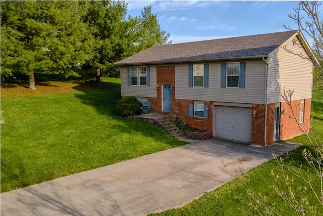split foyer home featuring a garage, concrete driveway, a shingled roof, a front yard, and brick siding