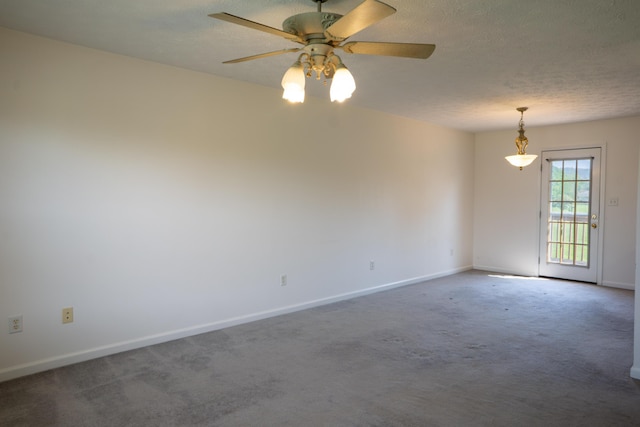unfurnished room with carpet, a ceiling fan, and baseboards