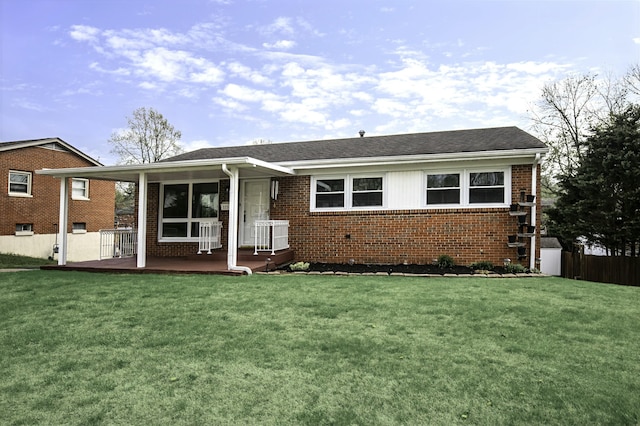 single story home featuring brick siding, a front lawn, fence, and covered porch