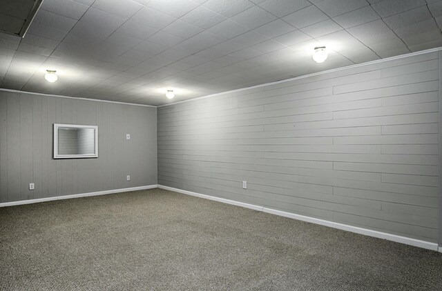 spare room with baseboards, crown molding, and carpet floors