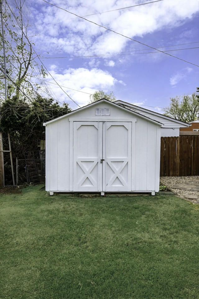 view of shed featuring fence