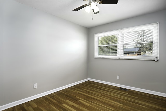 unfurnished room with wood finished floors, baseboards, a ceiling fan, and visible vents