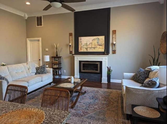 living room with ceiling fan, ornamental molding, visible vents, recessed lighting, and baseboards