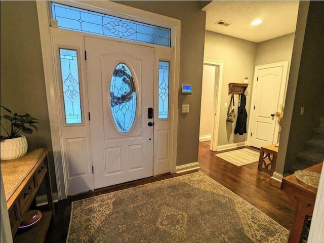 entryway with baseboards, dark wood-style floors, and visible vents