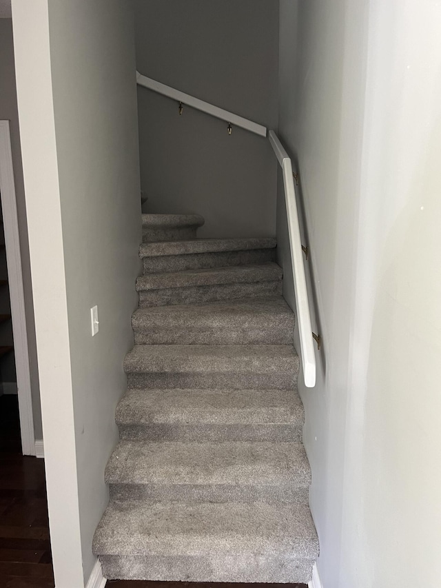stairs featuring wood finished floors