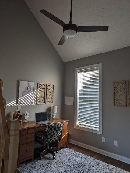 office space featuring vaulted ceiling, baseboards, wood finished floors, and ceiling fan