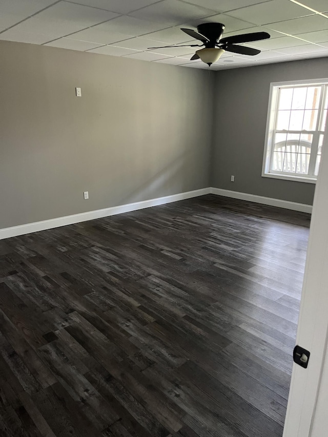 unfurnished room with dark wood-type flooring, baseboards, and ceiling fan