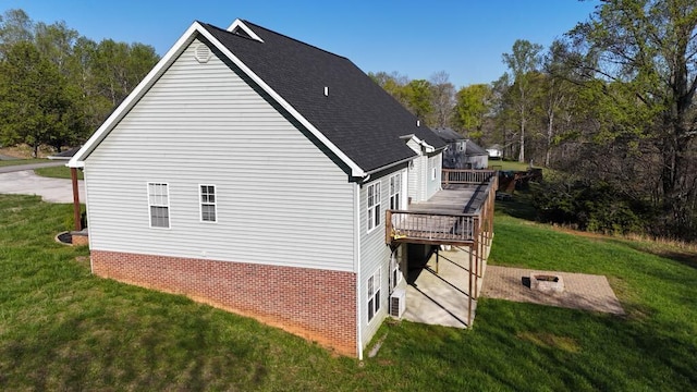 view of property exterior with a yard and a wooden deck