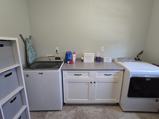 1778 Elkin Station Rd, Winchester, KY 40391 - clothes washing area with cabinet space, washer and clothes dryer, and light tile patterned flooring
