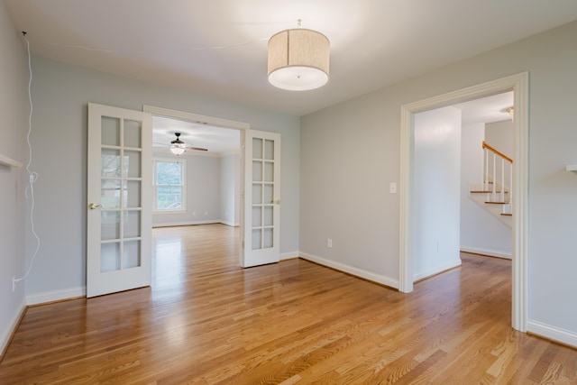 unfurnished dining area with french doors, baseboards, and light wood-style floors