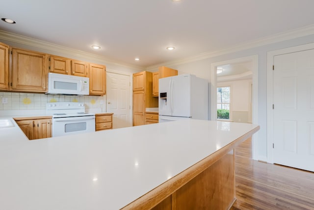 kitchen featuring decorative backsplash, white appliances, crown molding, light countertops, and wood finished floors