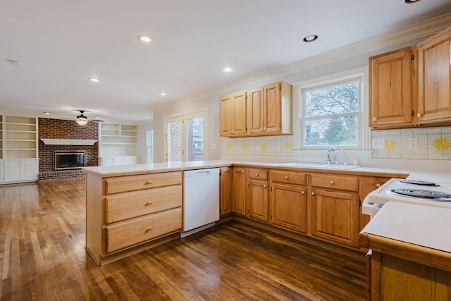 kitchen with a sink, white appliances, a ceiling fan, a peninsula, and light countertops