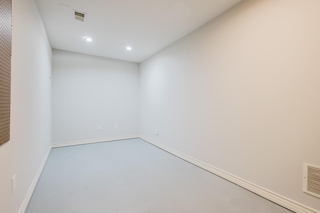 empty room featuring recessed lighting, concrete flooring, baseboards, and visible vents