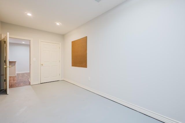 unfurnished bedroom featuring baseboards, recessed lighting, and finished concrete floors