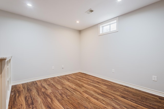 below grade area featuring wood finished floors, recessed lighting, visible vents, and baseboards