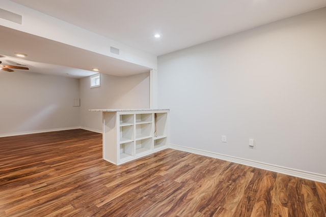 below grade area featuring baseboards, recessed lighting, wood finished floors, and a ceiling fan