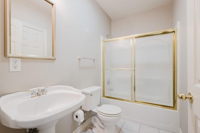 full bathroom with shower / bath combination with glass door, toilet, tile patterned flooring, and a sink