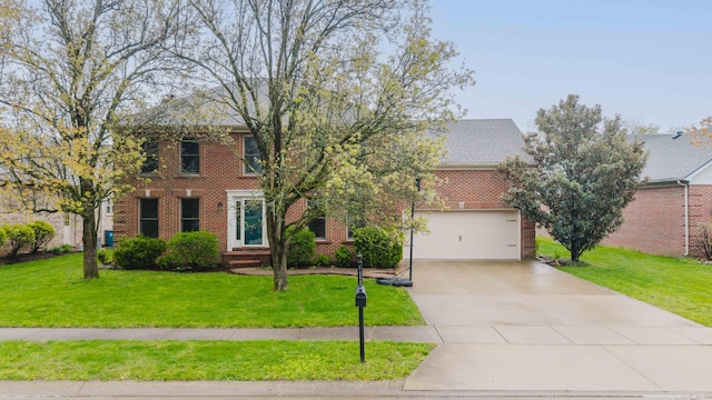 colonial inspired home with driveway, a front lawn, an attached garage, and brick siding