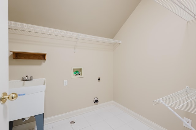 laundry area with hookup for an electric dryer, light tile patterned floors, baseboards, hookup for a washing machine, and laundry area