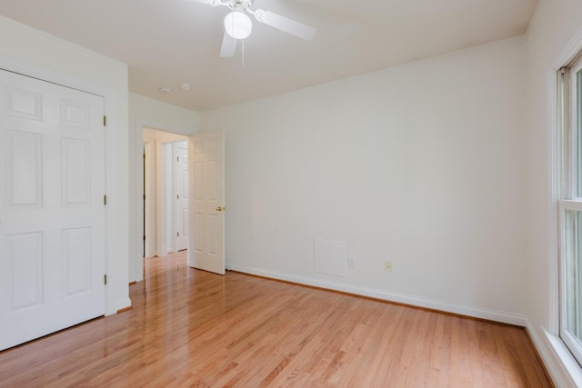 unfurnished bedroom featuring baseboards, a ceiling fan, and light wood finished floors