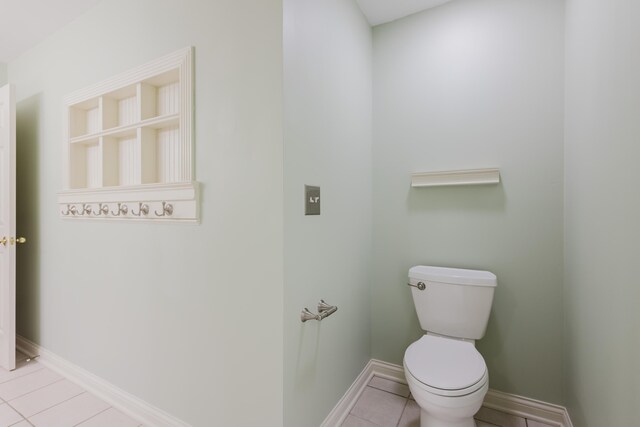 bathroom featuring tile patterned floors, toilet, and baseboards