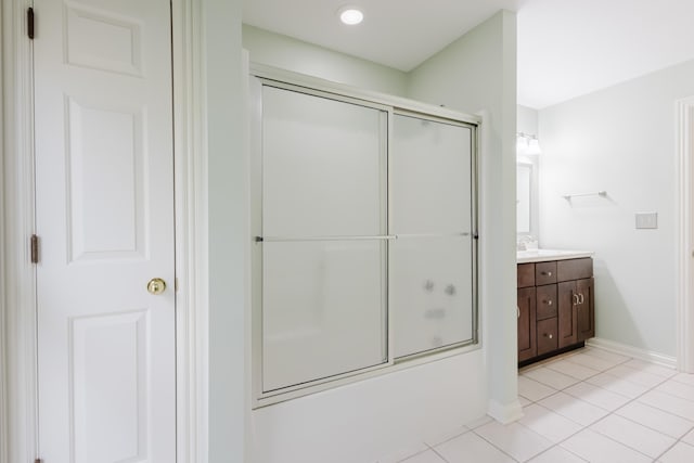 bathroom with baseboards, tile patterned flooring, and vanity