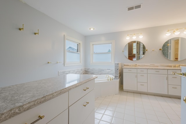 full bathroom with visible vents, vanity, and a bath