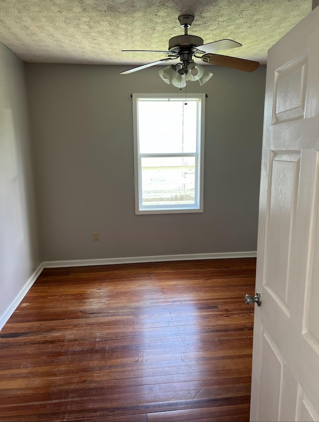 115 Georgia St, Winchester, KY 40391 - unfurnished room with a textured ceiling, baseboards, a ceiling fan, and dark wood finished floors
