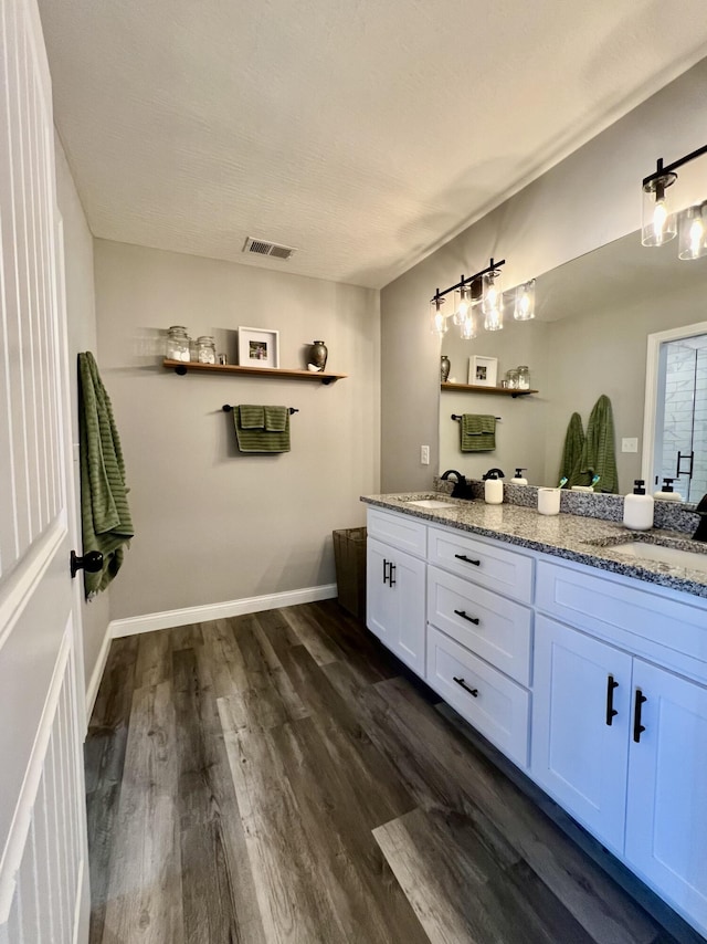 108 Allyson Cir, Junction City, KY 40440 - full bathroom with double vanity, visible vents, a sink, and wood finished floors