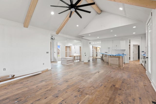 living room with high vaulted ceiling, beamed ceiling, light wood-style flooring, a ceiling fan, and recessed lighting