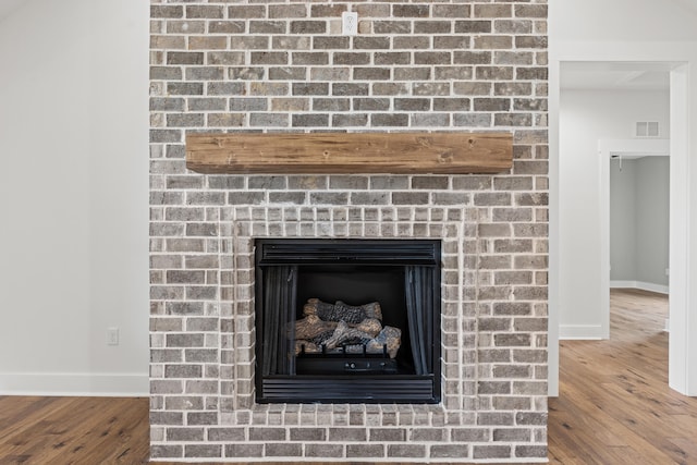 215 Berkley Hall Dr, Berea, KY 40403 - detailed view of baseboards, a brick fireplace, and wood finished floors