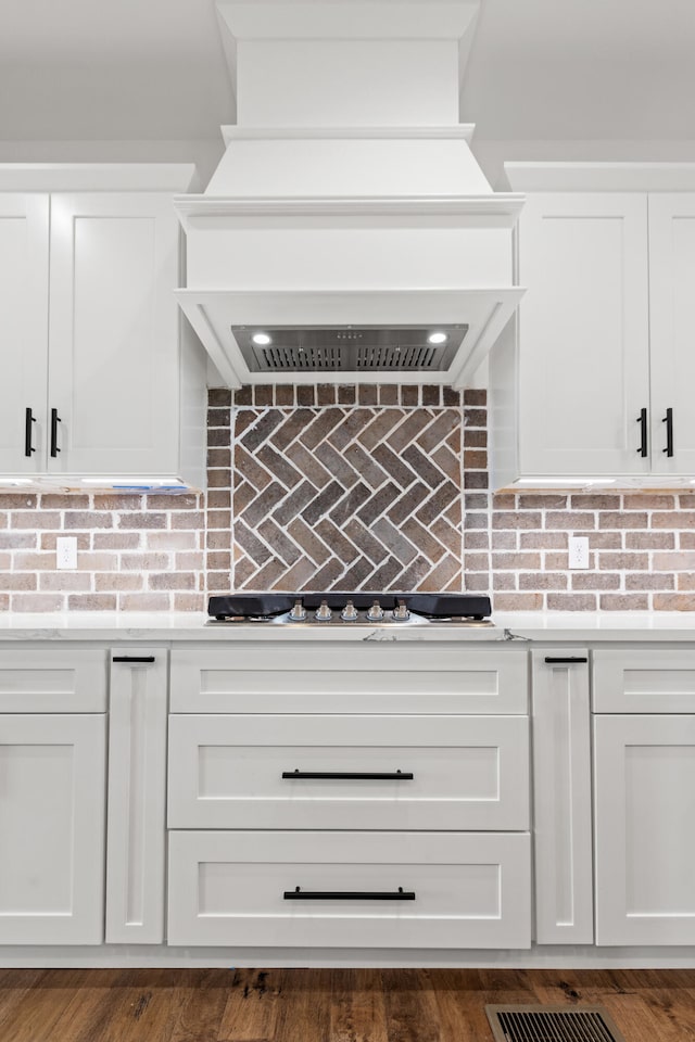 215 Berkley Hall Dr, Berea, KY 40403 - kitchen featuring premium range hood, light countertops, white cabinetry, and decorative backsplash