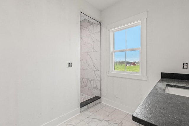 entryway featuring a sink, marble finish floor, and baseboards