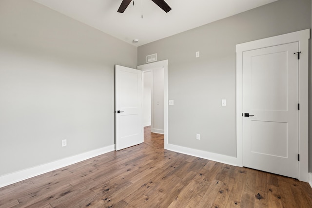 215 Berkley Hall Dr, Berea, KY 40403 - unfurnished bedroom with wood finished floors, baseboards, and a ceiling fan