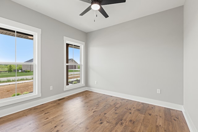 215 Berkley Hall Dr, Berea, KY 40403 - spare room with wood-type flooring, a ceiling fan, and baseboards
