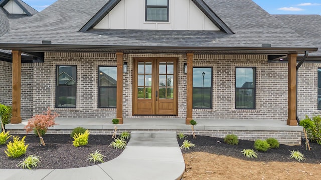 215 Berkley Hall Dr, Berea, KY 40403 - view of exterior entry featuring board and batten siding, brick siding, and a shingled roof