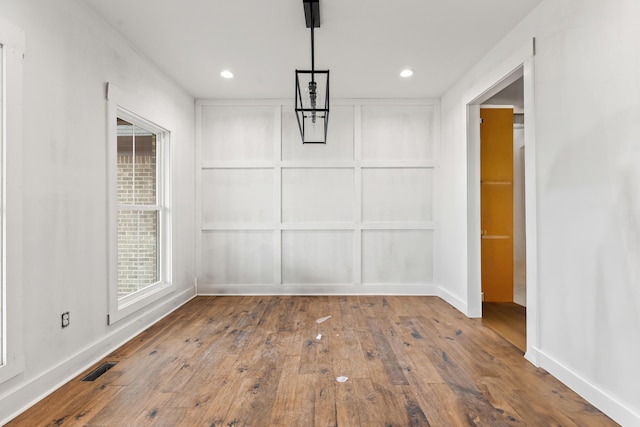 unfurnished dining area featuring recessed lighting, wood-type flooring, and visible vents