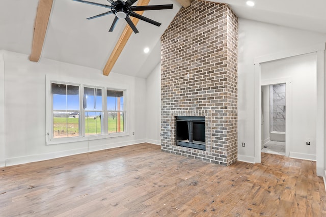 unfurnished living room featuring beam ceiling, high vaulted ceiling, wood-type flooring, and a ceiling fan