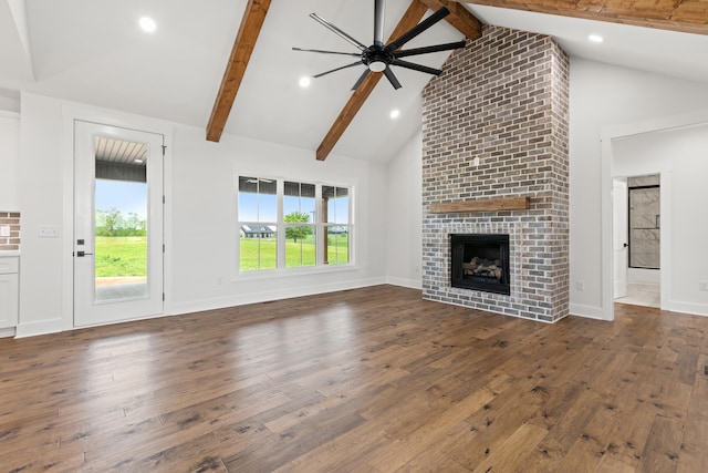 215 Berkley Hall Dr, Berea, KY 40403 - unfurnished living room featuring hardwood / wood-style flooring, ceiling fan, beam ceiling, a brick fireplace, and high vaulted ceiling