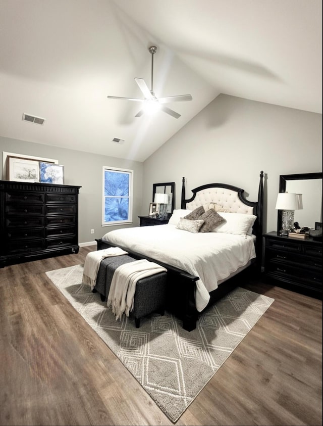 bedroom with ceiling fan, vaulted ceiling, wood finished floors, and visible vents