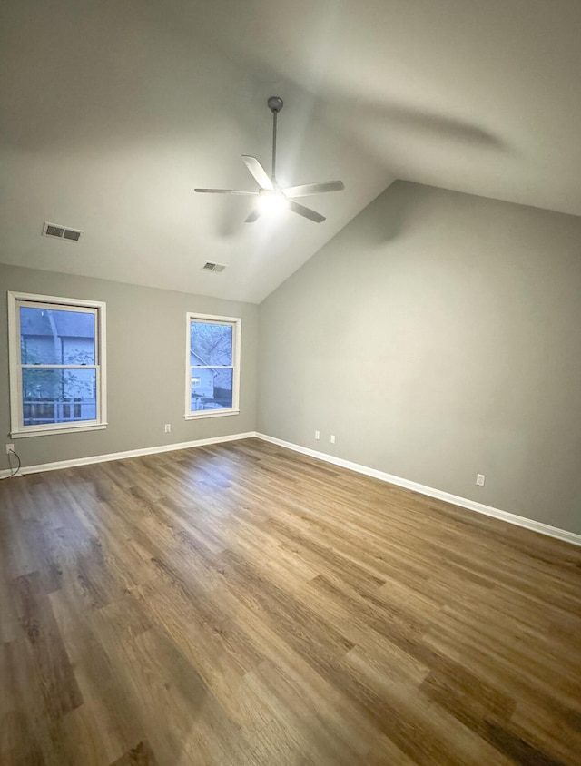 spare room with dark wood-style flooring, visible vents, baseboards, and ceiling fan