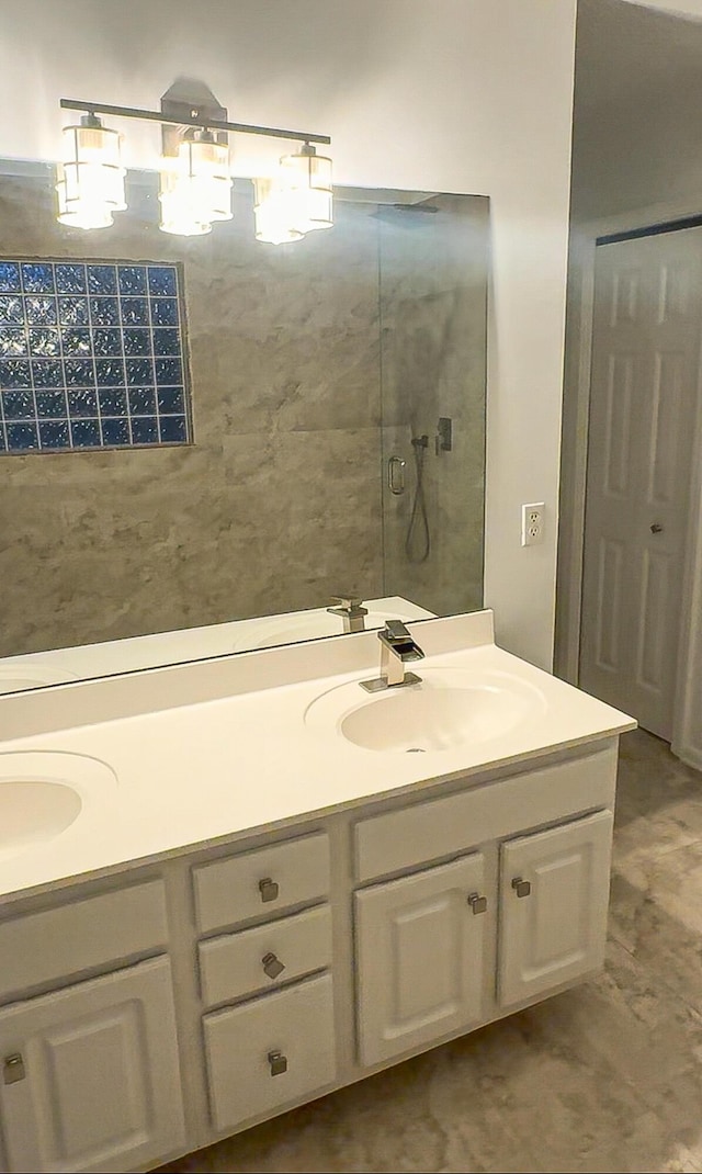 full bathroom featuring walk in shower, a sink, and double vanity