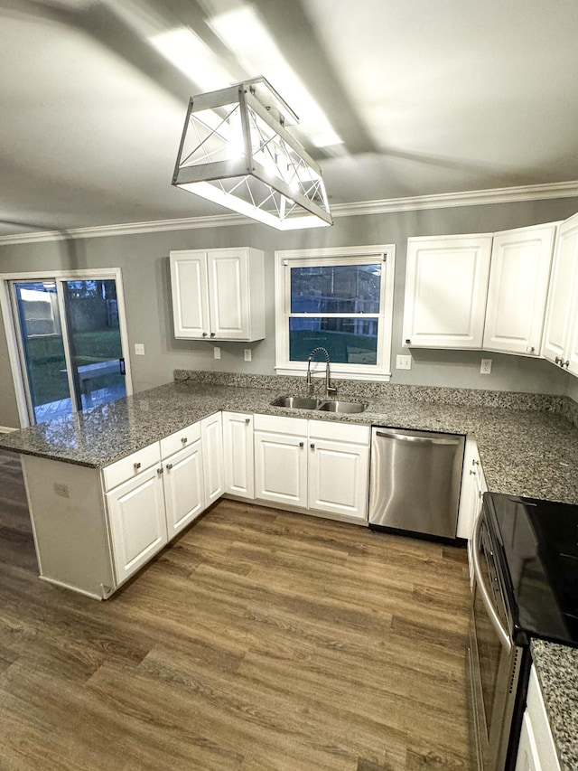 kitchen featuring white cabinets, a sink, appliances with stainless steel finishes, and crown molding