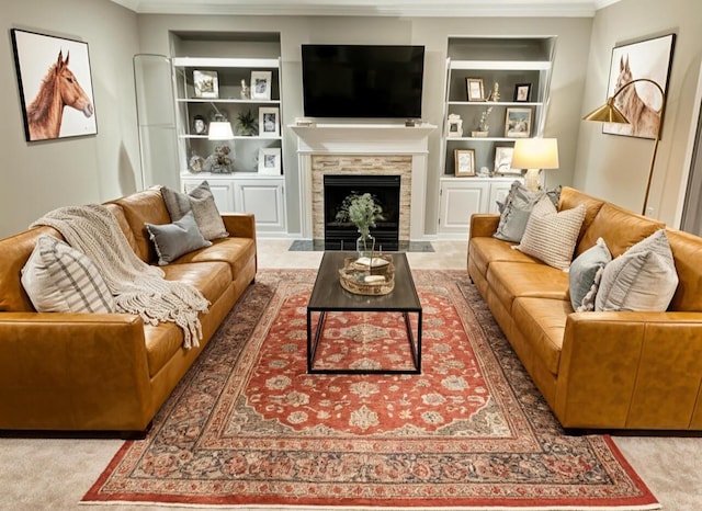 living area featuring built in features, a fireplace, carpet flooring, and crown molding