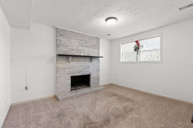 unfurnished living room featuring carpet flooring, visible vents, a fireplace, and baseboards