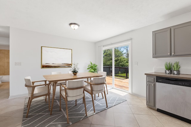 dining area with light tile patterned floors and baseboards