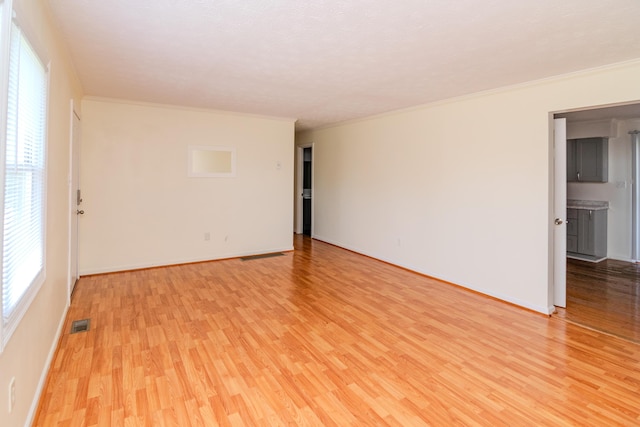 406 Kenway St, Berea, KY 40403 - unfurnished room featuring light wood-style floors, visible vents, baseboards, and ornamental molding