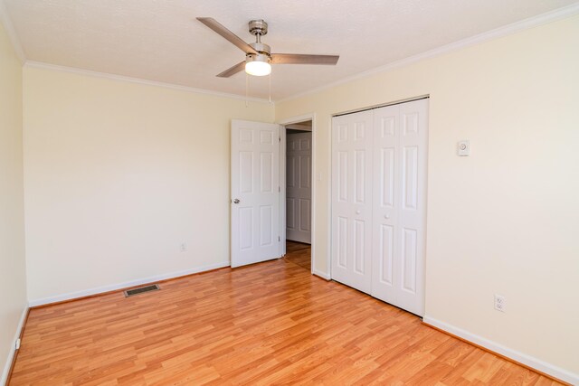 406 Kenway St, Berea, KY 40403 - unfurnished bedroom with crown molding, a closet, light wood-type flooring, baseboards, and visible vents